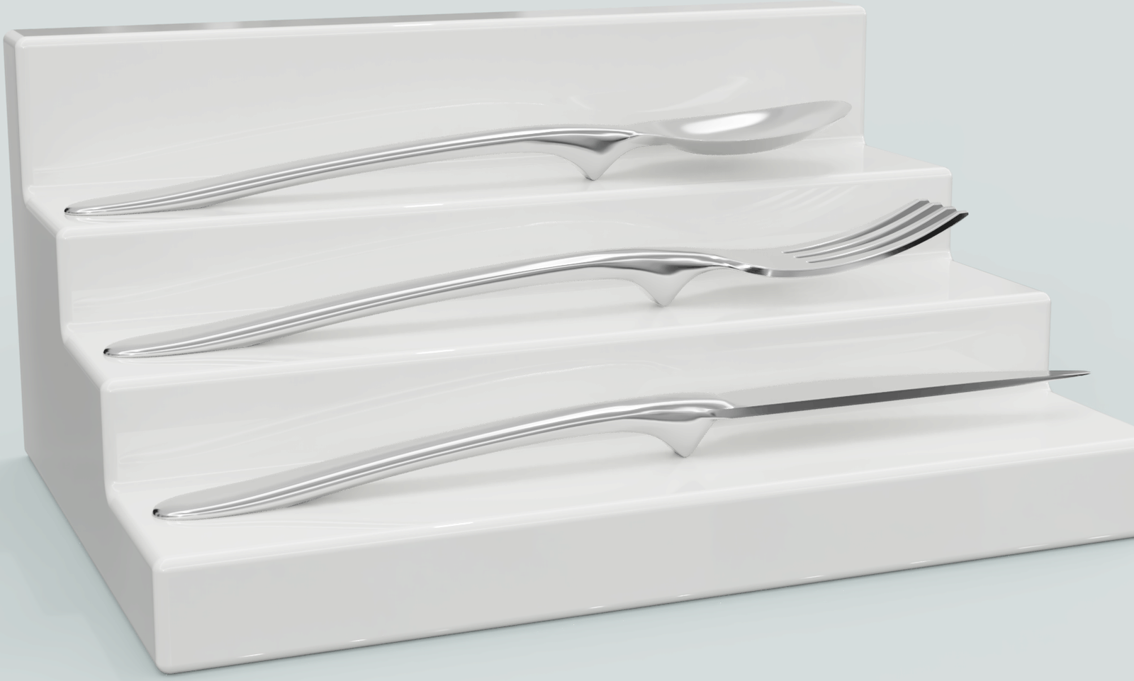 Floatware spoon, fork and knife resting on stepped pedestals, heads floating above the surface